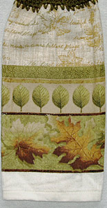 green and golden leaves on hanging kitchen hand towel