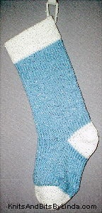 Light Blue knitted Christmas stocking with Christmas White yarn cuff, heel and toe with silver shiny metallic thread